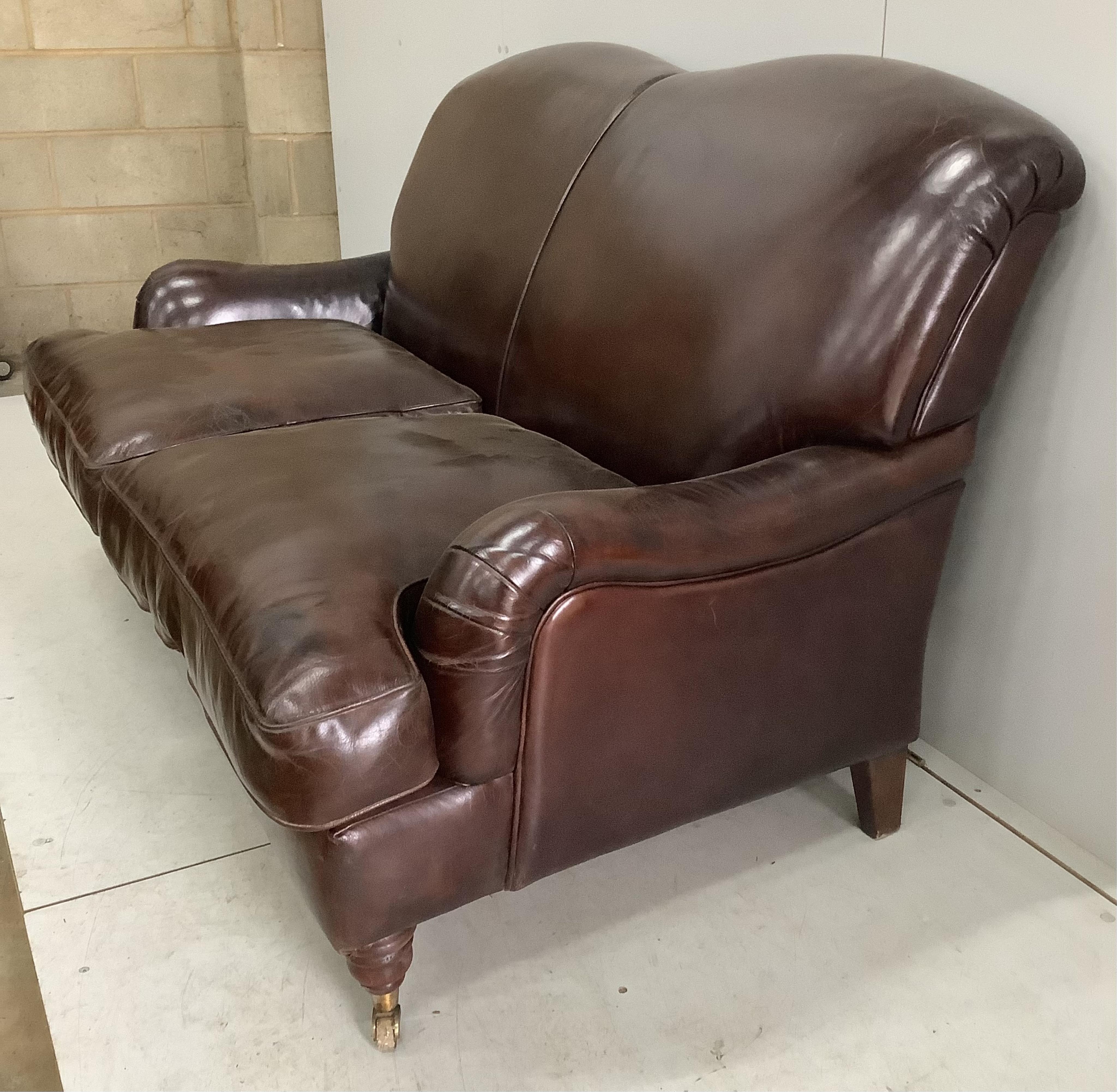 A modern Howard style brown leather two seater settee, width 158cm, depth 88cm, height 88cm. Condition - fair to good